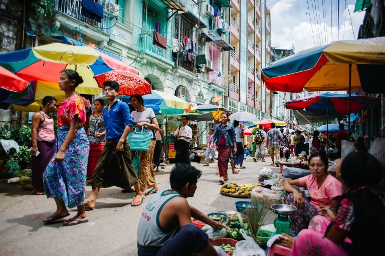 People transit in the street markets of the city of Yangon